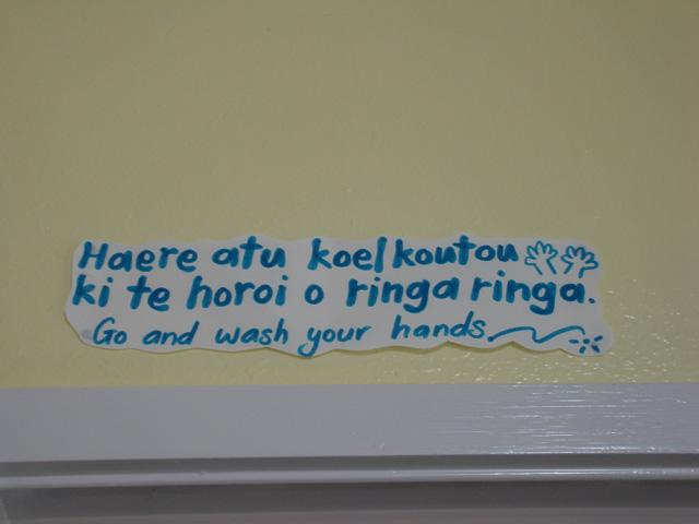 Paper stuck on the wall with direction in Māori and English