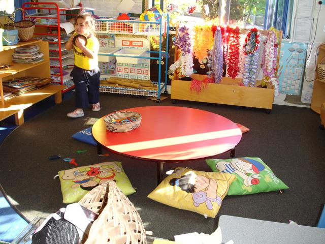 Child surrounded by cultural toys and items