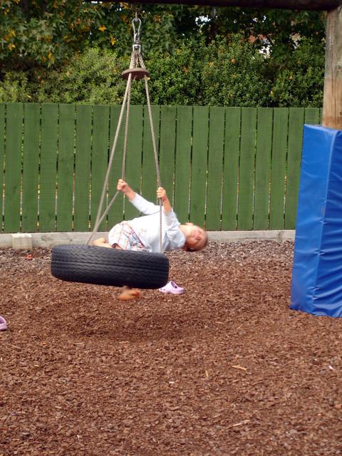 Child on a swing made from car tire