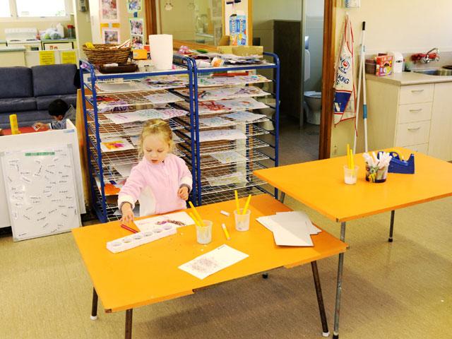 Girl painting in easy clean art area