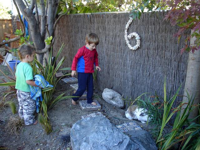 2 kids playing in the outdoor activity space