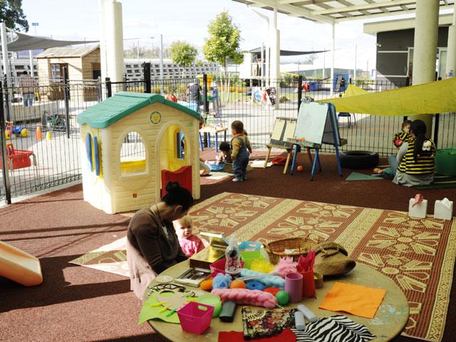 Securely fenced toddler area with soft flooring